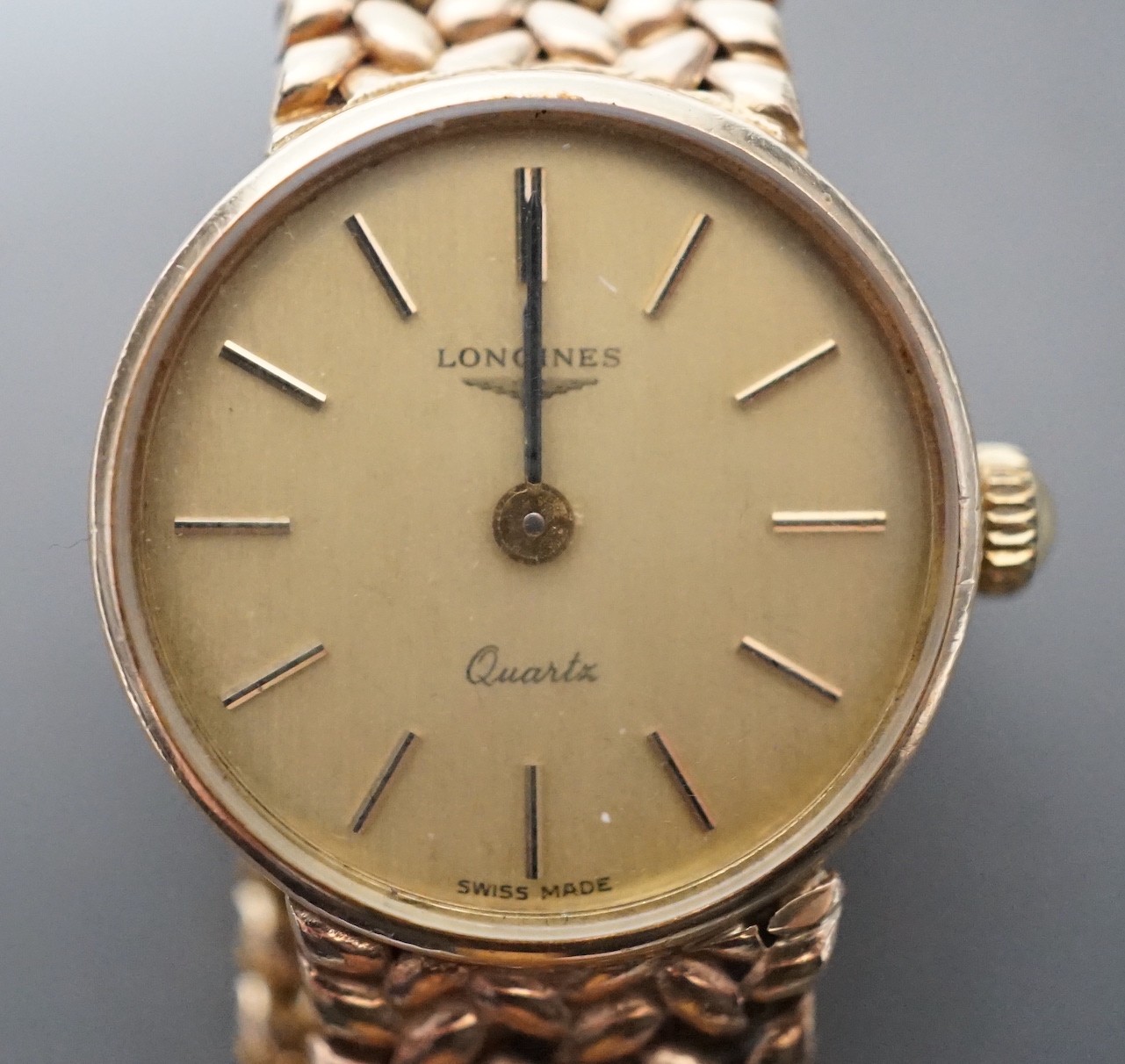 A lady's 9ct gold Longines quartz wrist watch on an inegral 9ct gold bracelet, with Longines box